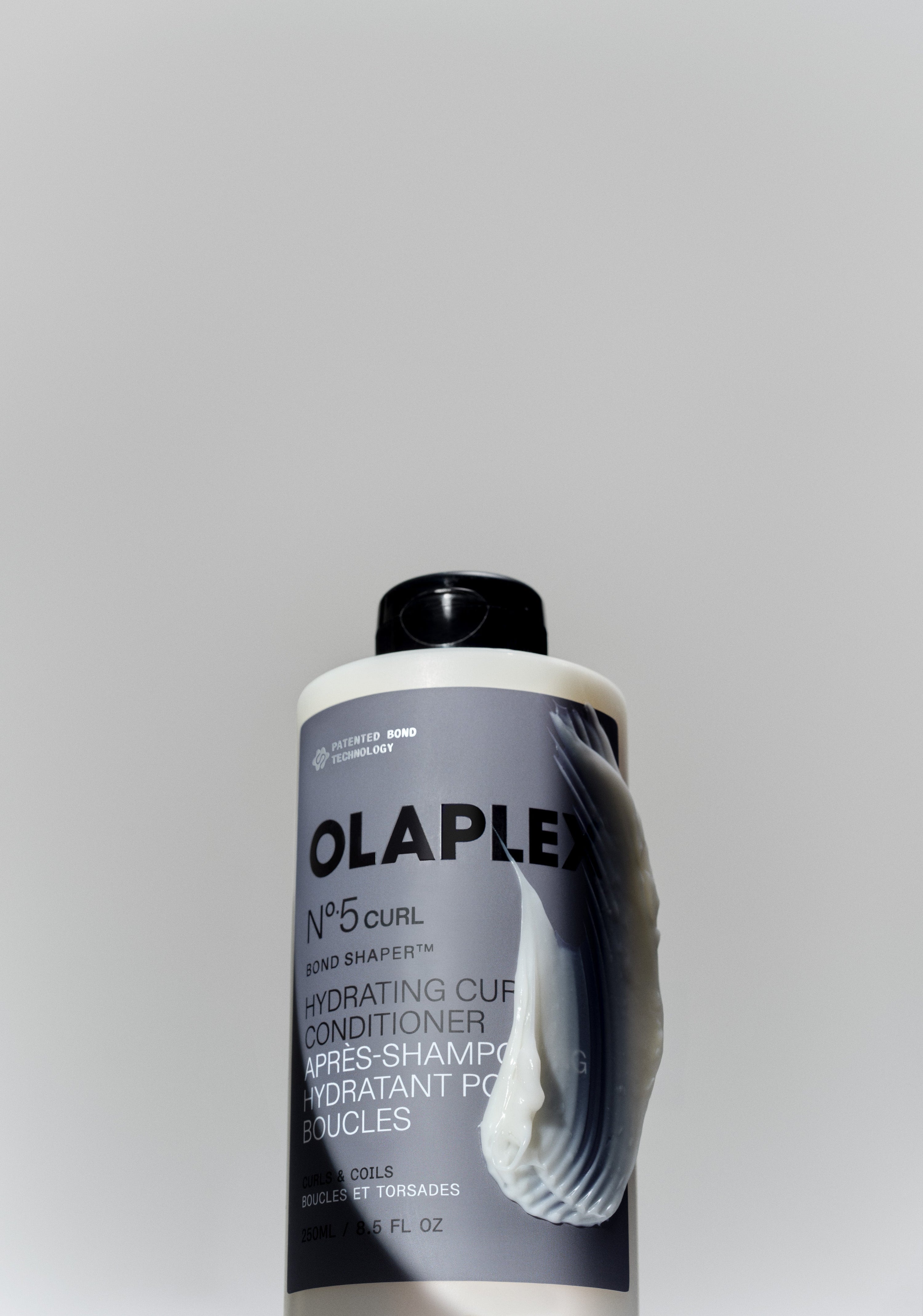 OLAPLEX N°.5Curl Conditioner Bottle with a smear of product on the side of the bottle 