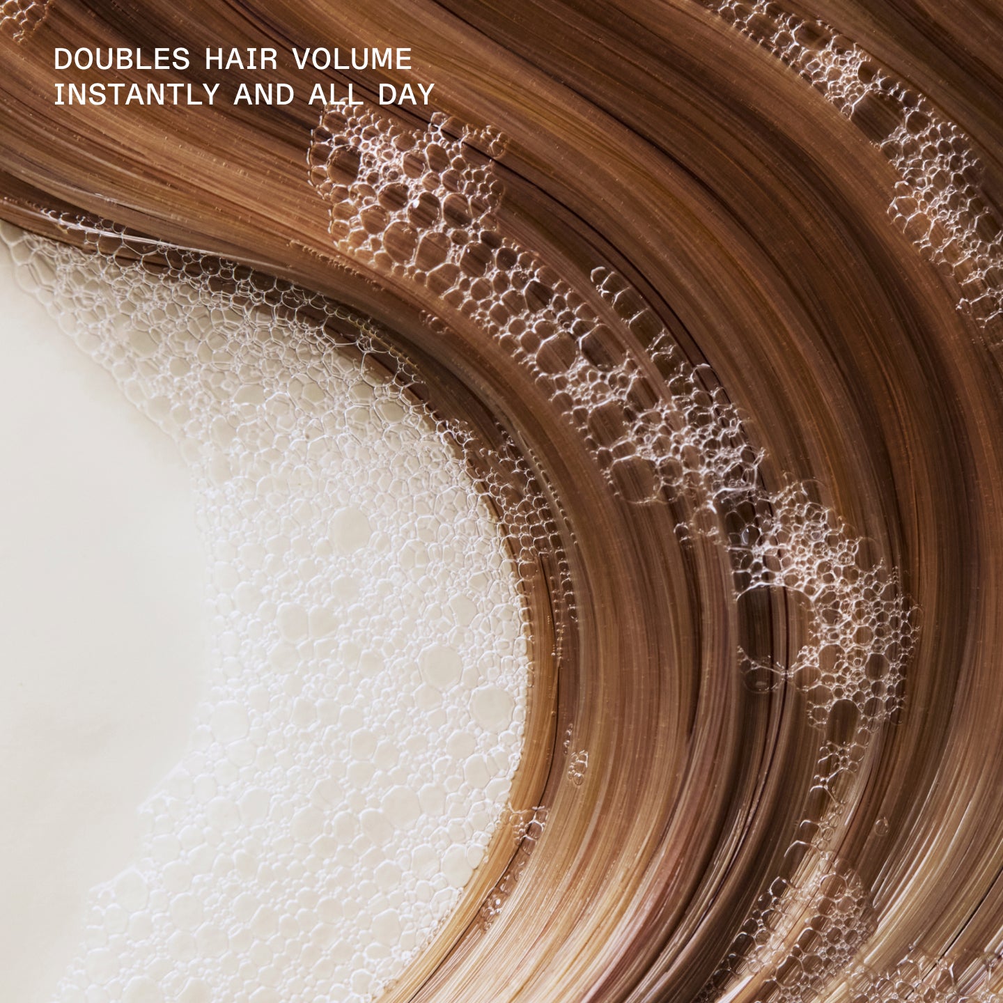 DOUBLES HAIR VOLUME INSTANTLY AND ALL DAY text on hair with shampoo