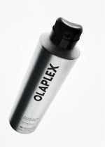 Olaplex Shape-Set Hair Spray in a sleek, metallic silver aerosol can with a black nozzle cap, shown at an angle on a clean white background.